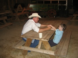 Nicolas arm wrestling the cook.