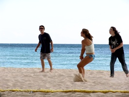 Julie preparing to receive a serve while Chris and Travis support