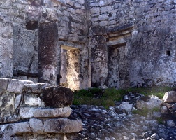 A slanted walkway leads up to worn pillars and a door to the inside of this building (we couldn't go up there).