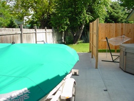 The boat on the extended pad from the new patio.  Hot tub and hammock on the far right.