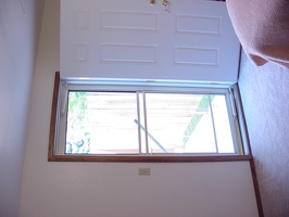 The screen door looking out on the new porch and new fench from inside the master bedroom.