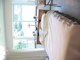 The bay window in the master bedroom.  I added the full-wide curtains and removed the louvres.