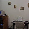 Living room wall with piano and entertainment center (view of music playlist on the monitor).