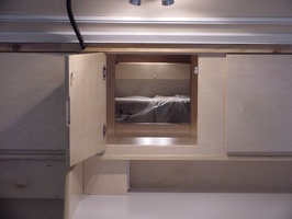 Looking through the center cabinet into the interior of the trailer.  The bed in this one can be folded up into a &quot;couch&qu