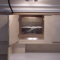 Looking through the center cabinet into the interior of the trailer.  The bed in this one can be folded up into a "couch&qu