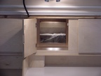 Looking through the center cabinet into the interior of the trailer.  The bed in this one can be folded up into a &quot;couch&qu