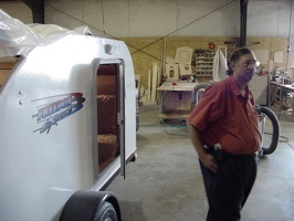 Mike Quinlan and the trailer with the shop in the background.