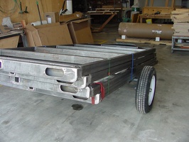 These are the trailer under-carriages.  There are four here with the one on the bottom fitted for wheels.  These are ready to go