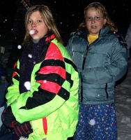 Unknown people at the bonfire (the white spots are large flakes of snow coming down)